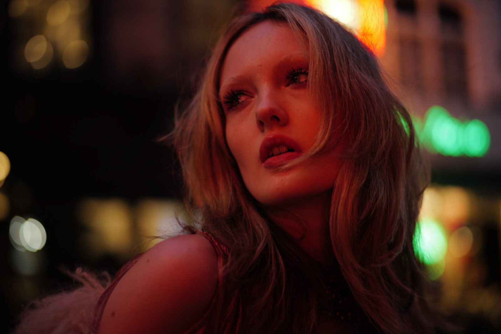 Night portrait lit by neon signs